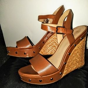 Brown Michael Kors studded wicker wedge heels.